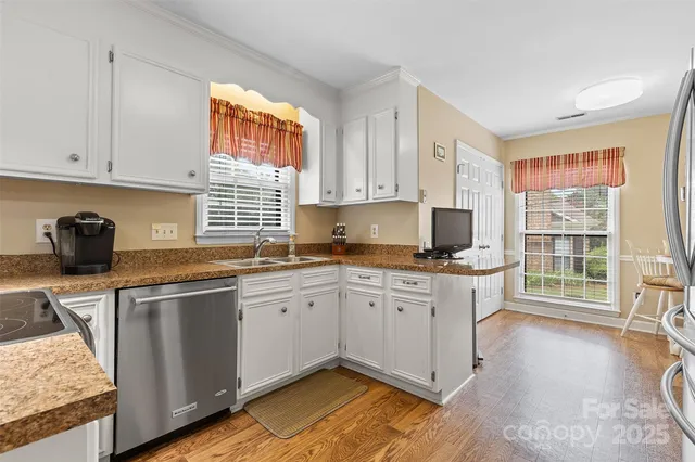 a kitchen with granite countertop a sink cabinets and window