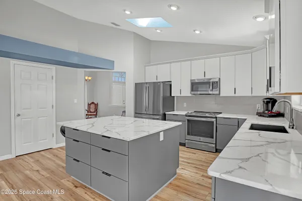 a kitchen with a sink stove and refrigerator