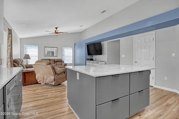 a living room with furniture and flat screen tv