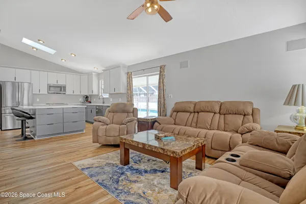 a living room with furniture and kitchen view