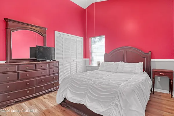 a bedroom with a bed and a flat screen tv