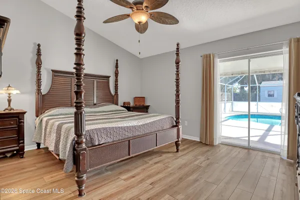 a bedroom with a bed and a large window