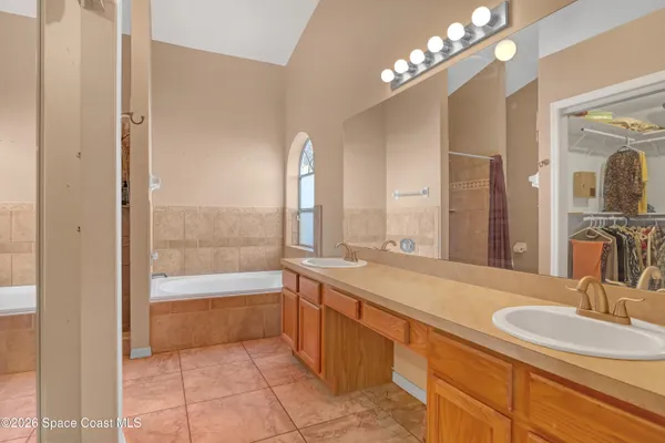 a bathroom with a tub sink and mirror
