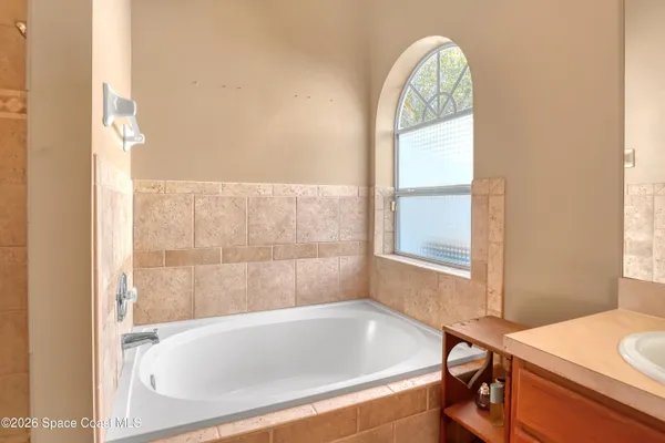 a bathroom with a bathtub and a window