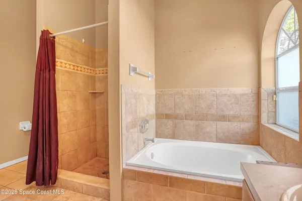 a bathroom with a tub and shower