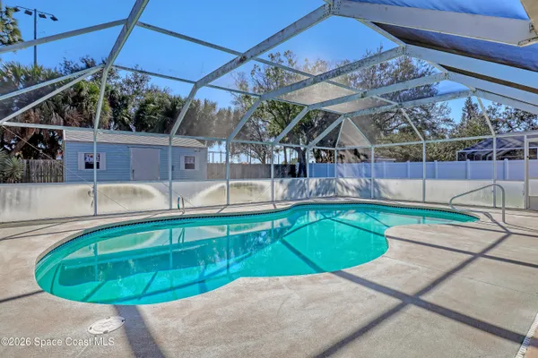 a view of a backyard with swimming pool