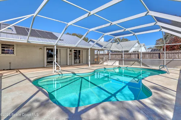 a view of a backyard with a swimming pool