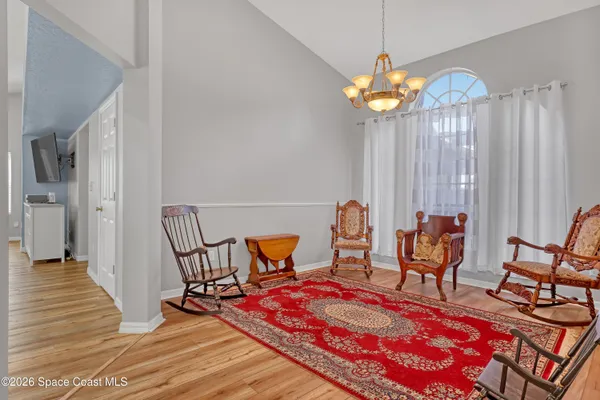 a bedroom with furniture and a chandelier