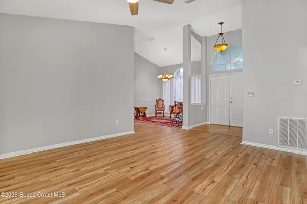a view of a room with wooden floor and window