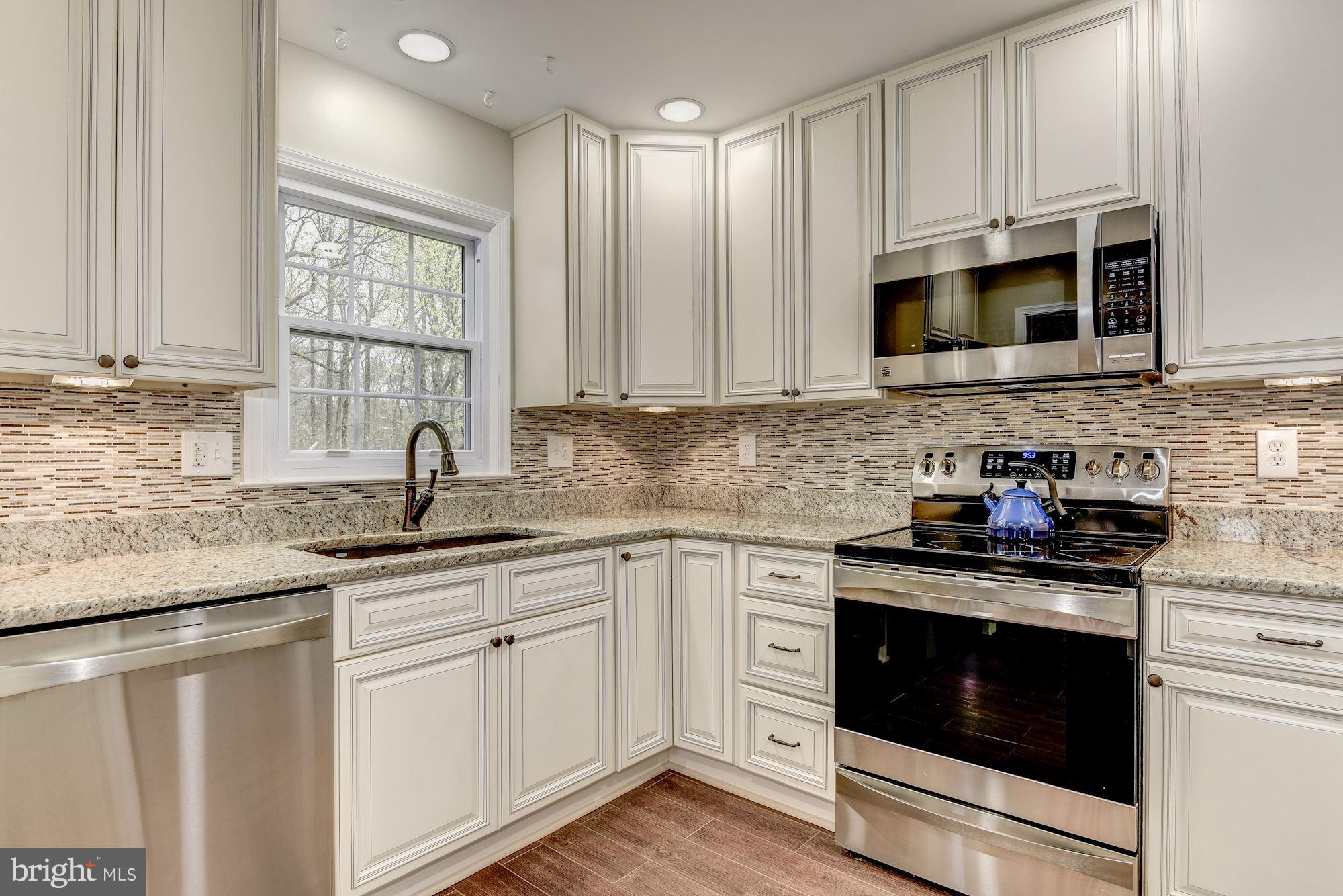 8913 Union Farm Road Alexandria, VA 22309 - Photo 8 of 30 Granite & stainless steel in remodeled kitchen