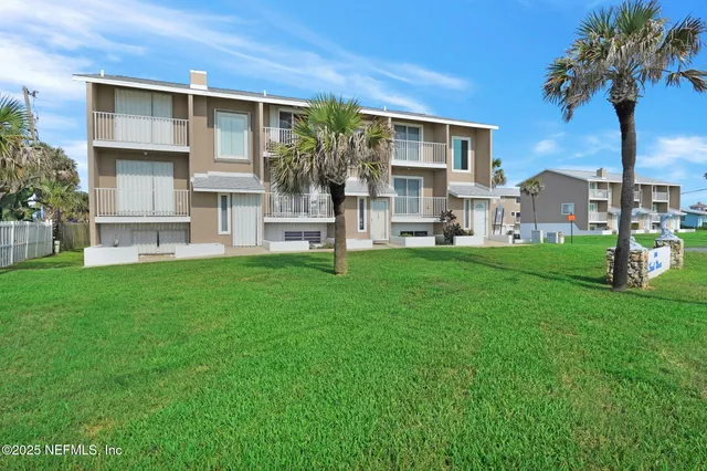 a view of a porch with chairs and potted plants