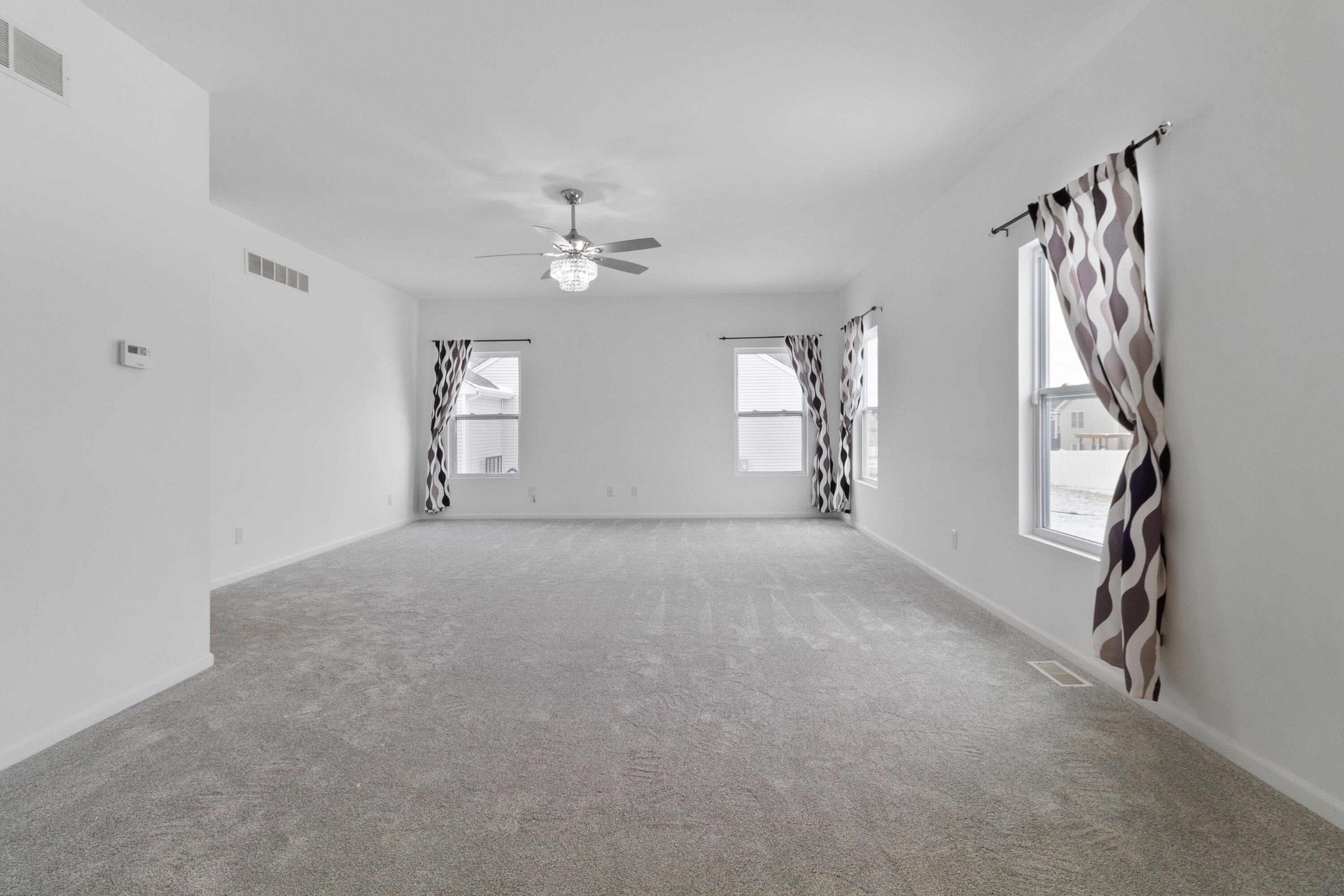 7485 Clark Street Merrillville, IN 46410 - Photo 11 of 26 a view of a livingroom with an empty space and a window