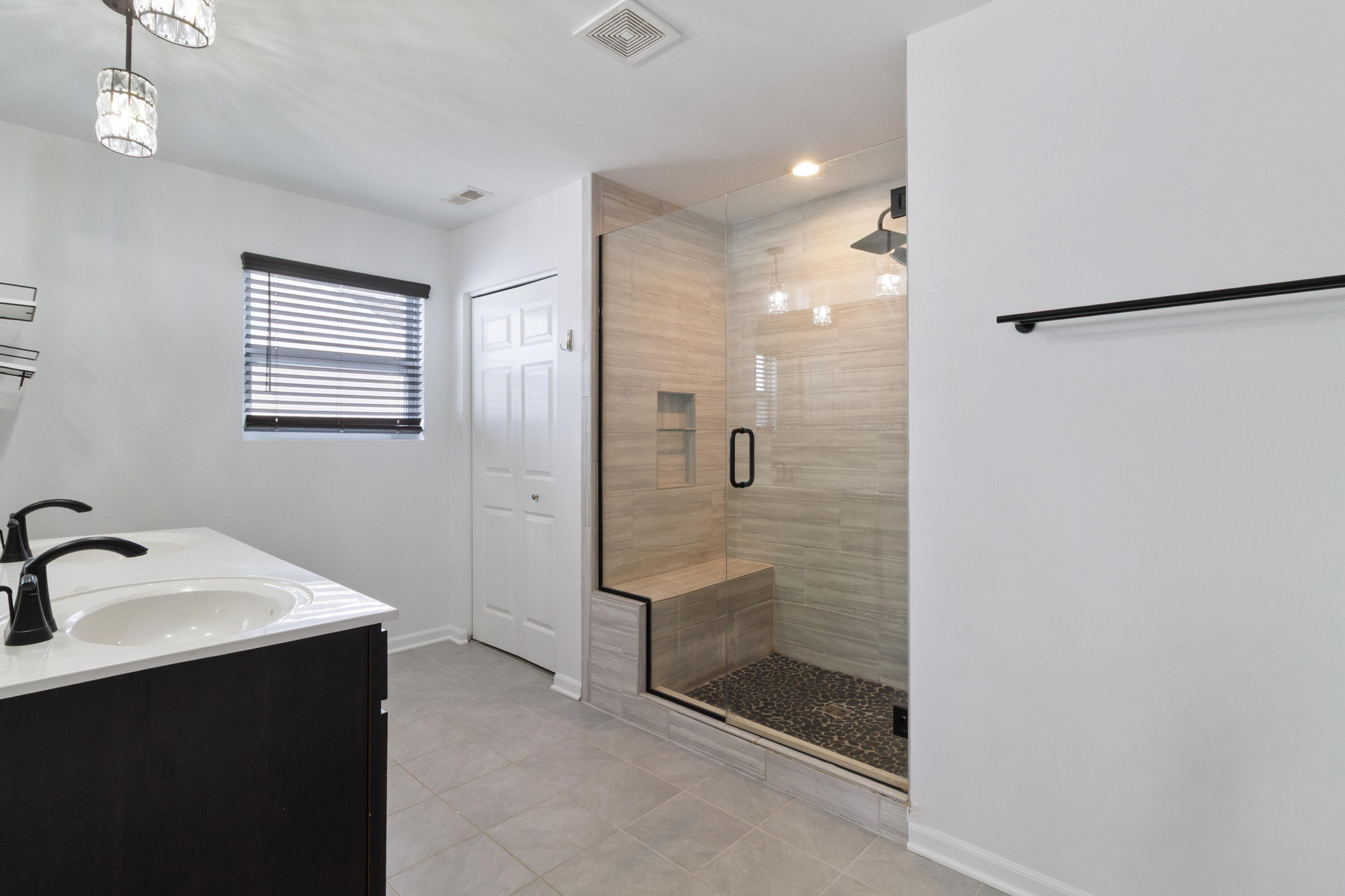 7485 Clark Street Merrillville, IN 46410 - Photo 18 of 26 a bathroom with a shower sink and mirror