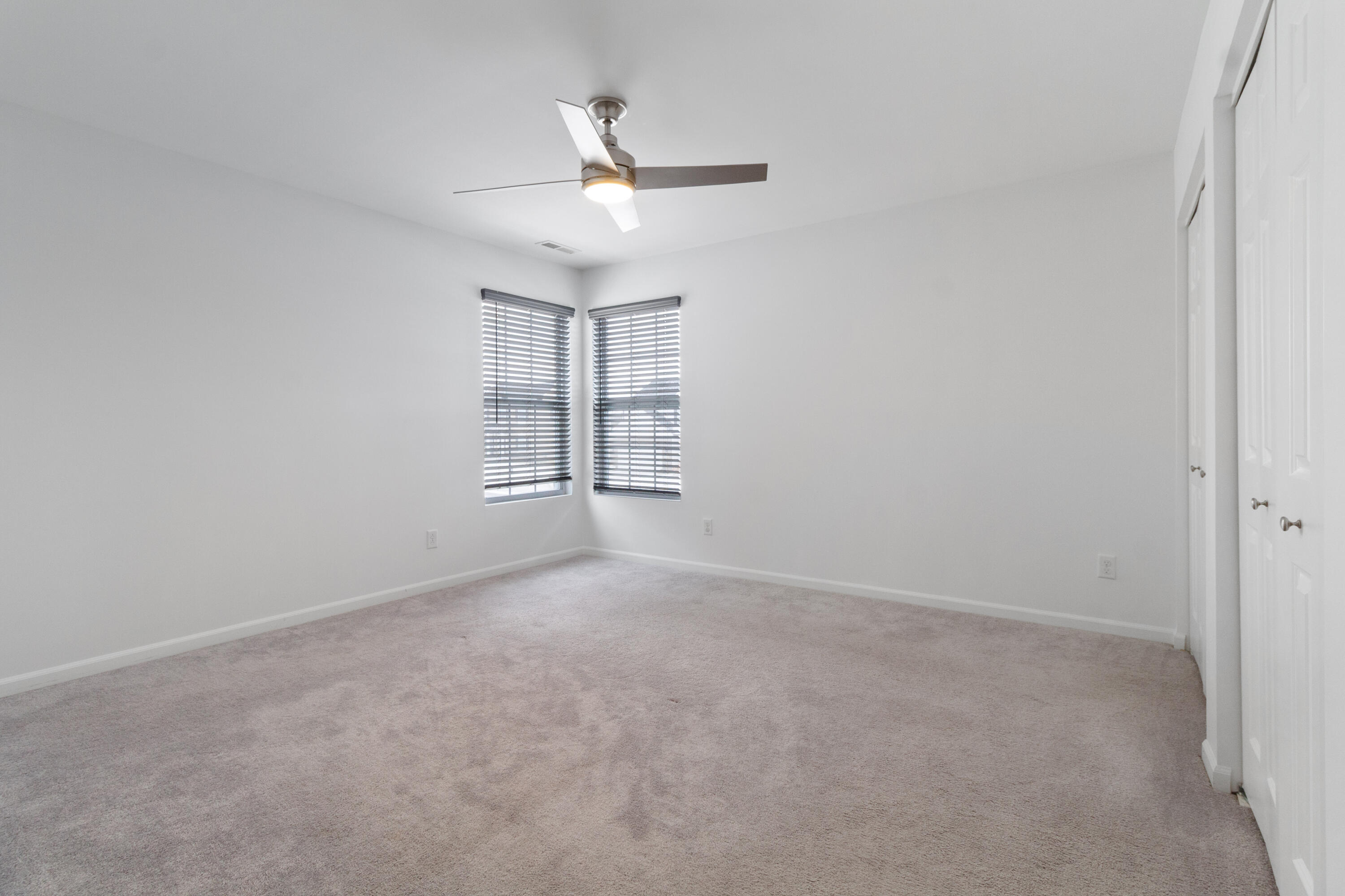 7485 Clark Street Merrillville, IN 46410 - Photo 22 of 26 an empty room with windows and fan
