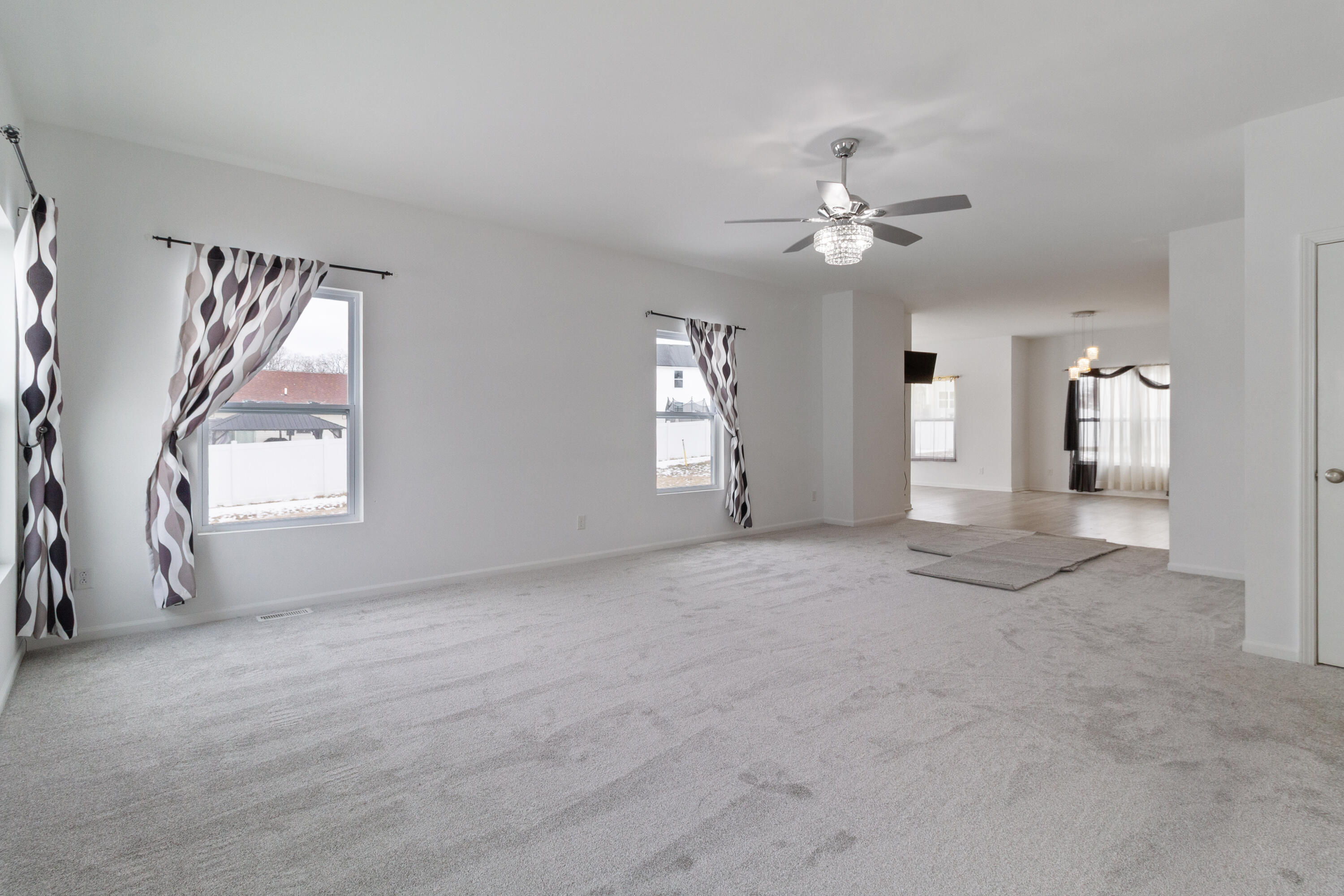 7485 Clark Street Merrillville, IN 46410 - Photo 10 of 26 a view of a livingroom with a ceiling fan and window