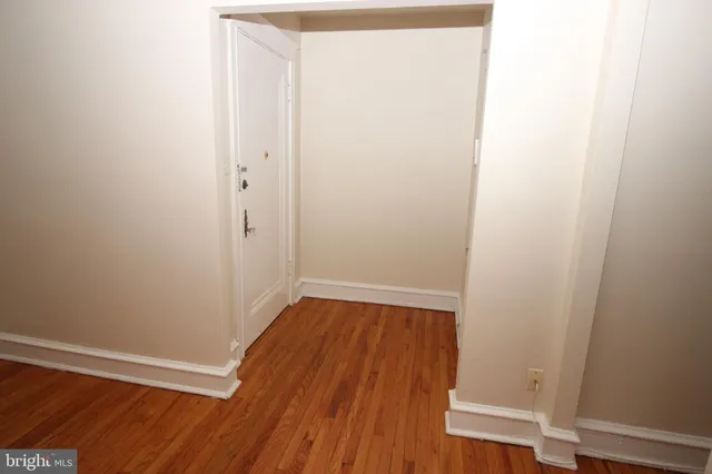 a view of a room with wooden floor