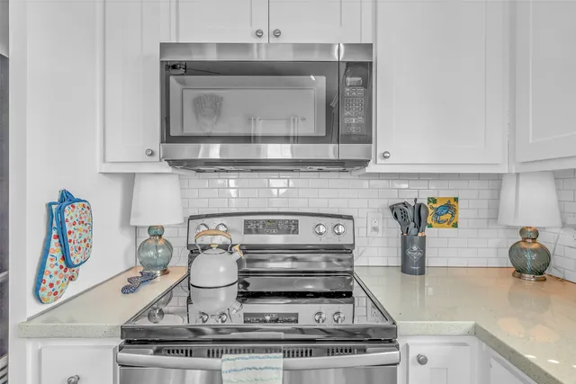 a stove top oven sitting inside of a kitchen