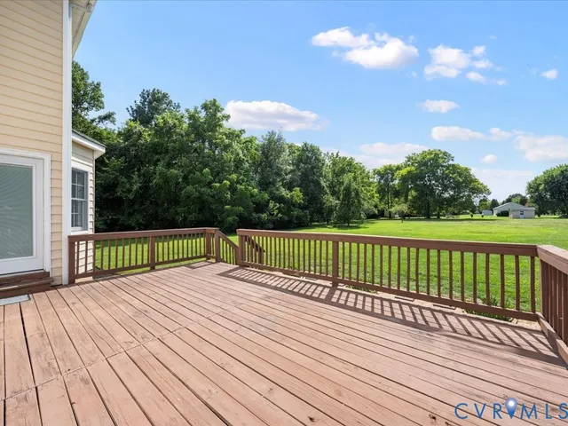 a view of balcony with wooden floor and fence