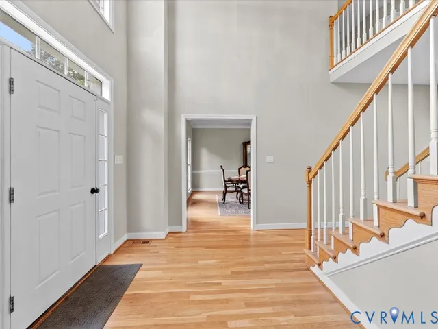 a view of a hallway view with wooden floor and staircase