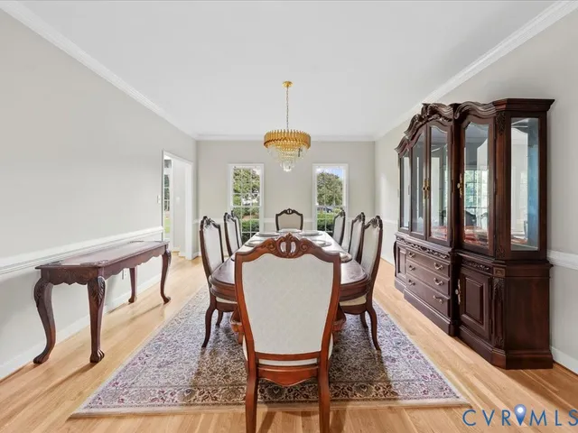 a dining room with furniture a rug and wooden floor