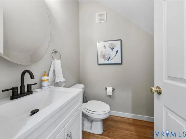 a bathroom with a toilet sink and vanity
