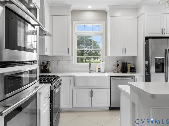 a kitchen with cabinets appliances and a window