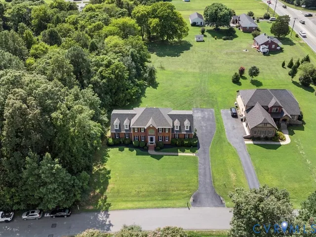 an aerial view of a house with a yard