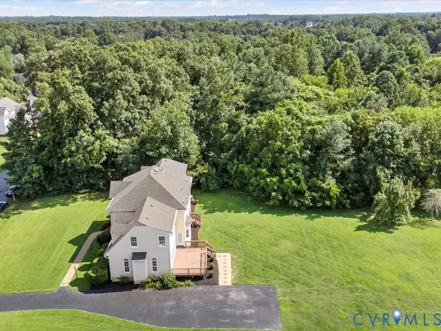 an aerial view of a house with yard