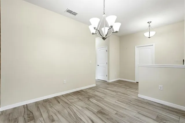 a large kitchen with kitchen island a large counter top space appliances and a sink