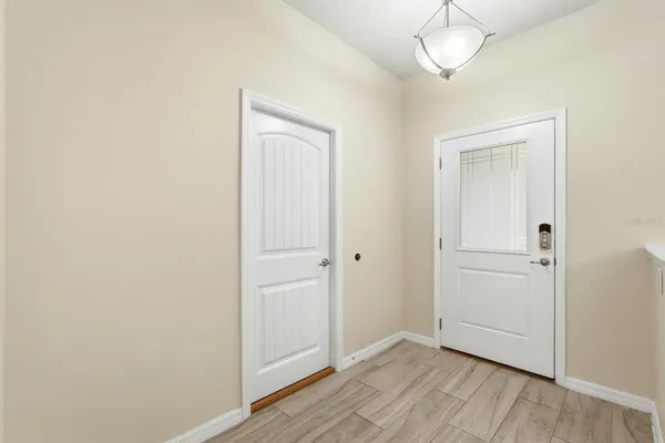 a kitchen with stainless steel appliances kitchen island granite countertop a stove a refrigerator and a dining table with wooden floor