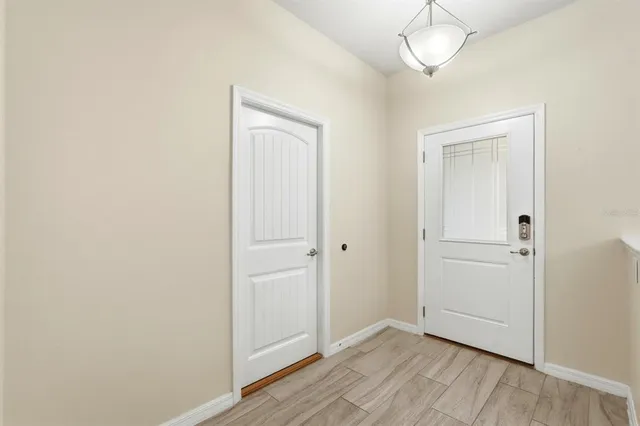 a kitchen with stainless steel appliances kitchen island granite countertop a stove a refrigerator and a dining table with wooden floor