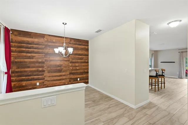 a kitchen with a sink a counter space and wooden floor