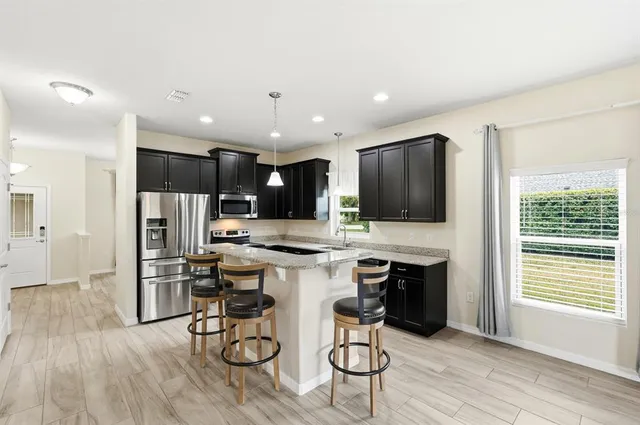 a kitchen with a refrigerator stove and microwave