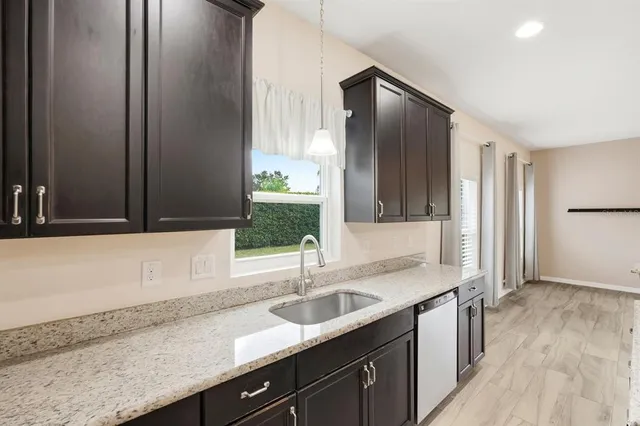 a view of a livingroom with furniture a ceiling fan wooden floor and a ceiling fan