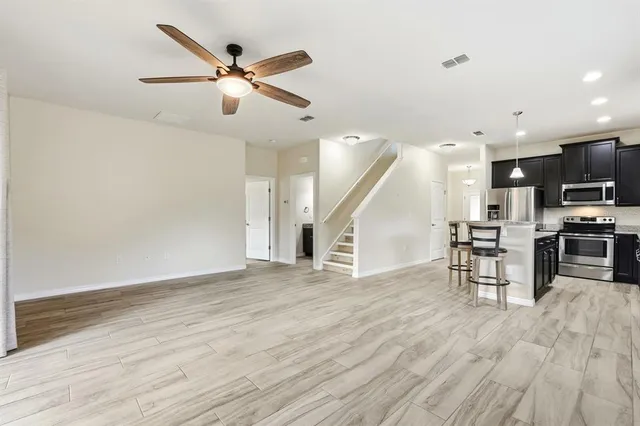 a view of a chairs and table in patio with a lake view