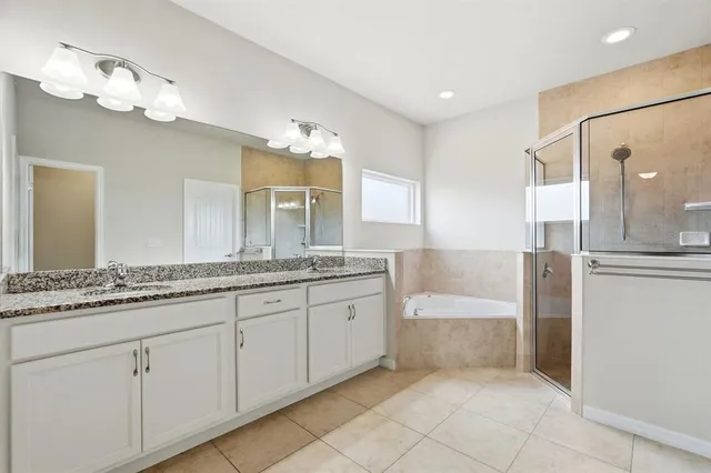 an empty room with wooden floor ceiling fan and windows