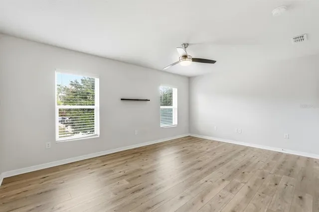 a bathroom with a granite countertop sink a toilet a mirror and bathtub