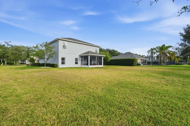 an aerial view of residential house with yard and swimming pool