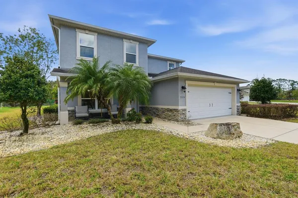 a view of a chandelier in big room with wooden floor