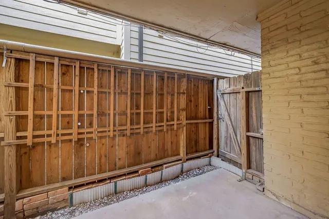 a view of a garage with wooden wall and a window