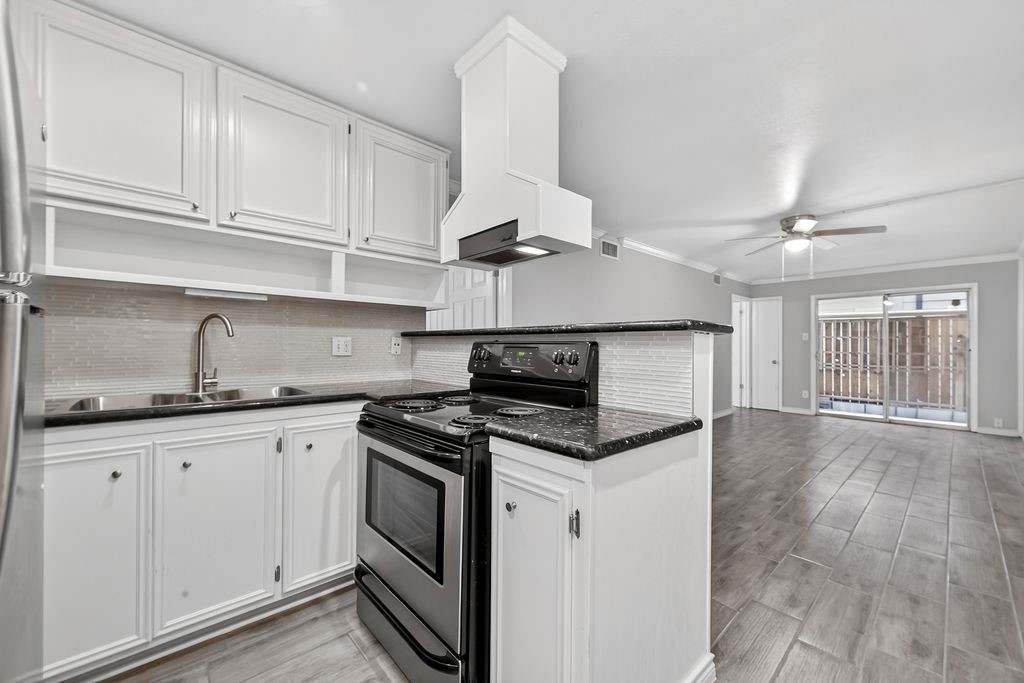 1418 Vermont Street, Unit 3 Houston, TX 77006 - Photo 3 of 11 a kitchen with granite countertop a sink stainless steel appliances and cabinets