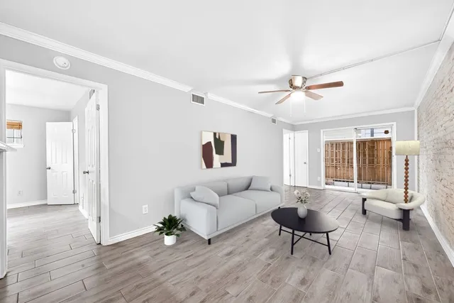 a living room with furniture and wooden floor