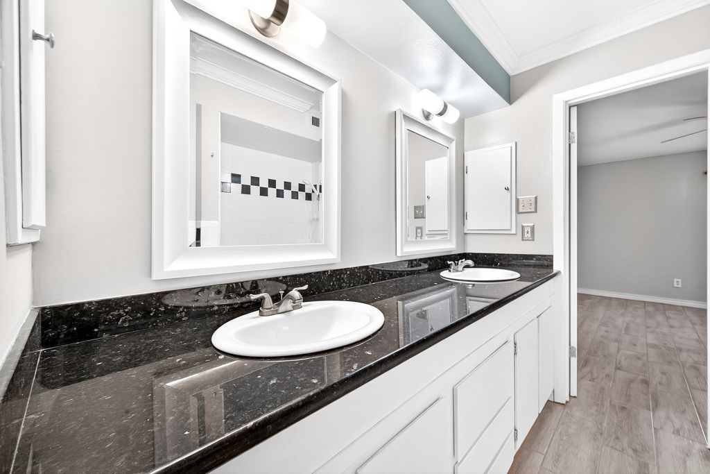 1418 Vermont Street, Unit 3 Houston, TX 77006 - Photo 6 of 11 a bathroom with a granite countertop sink and a mirror