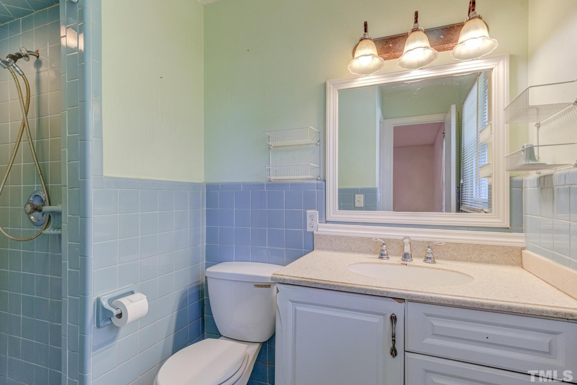 9101 Old Stage Road Raleigh, NC 27603 - Photo 36 of 60 a bathroom with a toilet sink and mirror