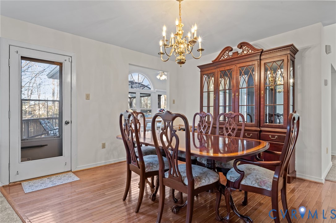518 Rebel Ridge Road Colonial Heights, VA 23834 - Photo 22 of 44 a view of a dining room with furniture wooden floor and chandelier