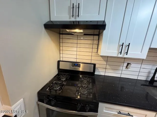 a stove top oven sitting inside of a kitchen