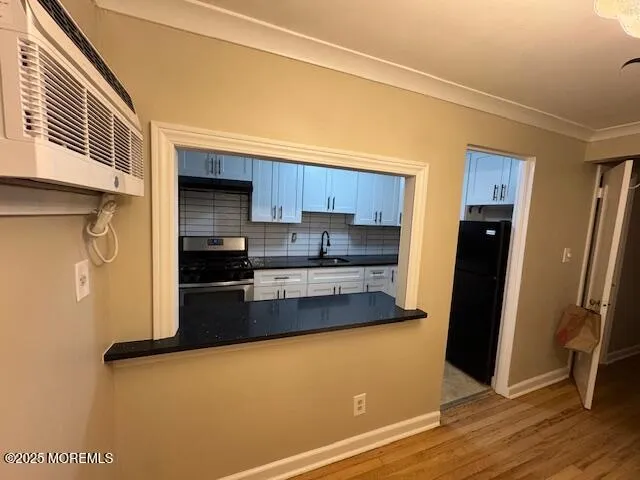 a kitchen with stainless steel appliances a refrigerator and a stove