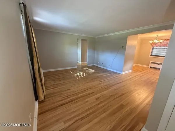 a view of a room with wooden floor