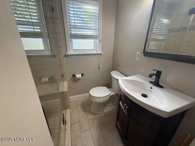 82 Manor Drive, Unit 803 Red Bank, NJ 07701 - Photo 23 of 39 a bathroom with a sink a toilet a mirror and a window