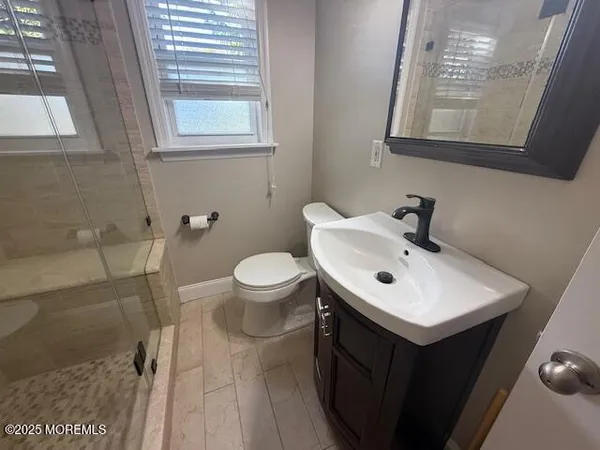 a bathroom with a sink mirror and toilet